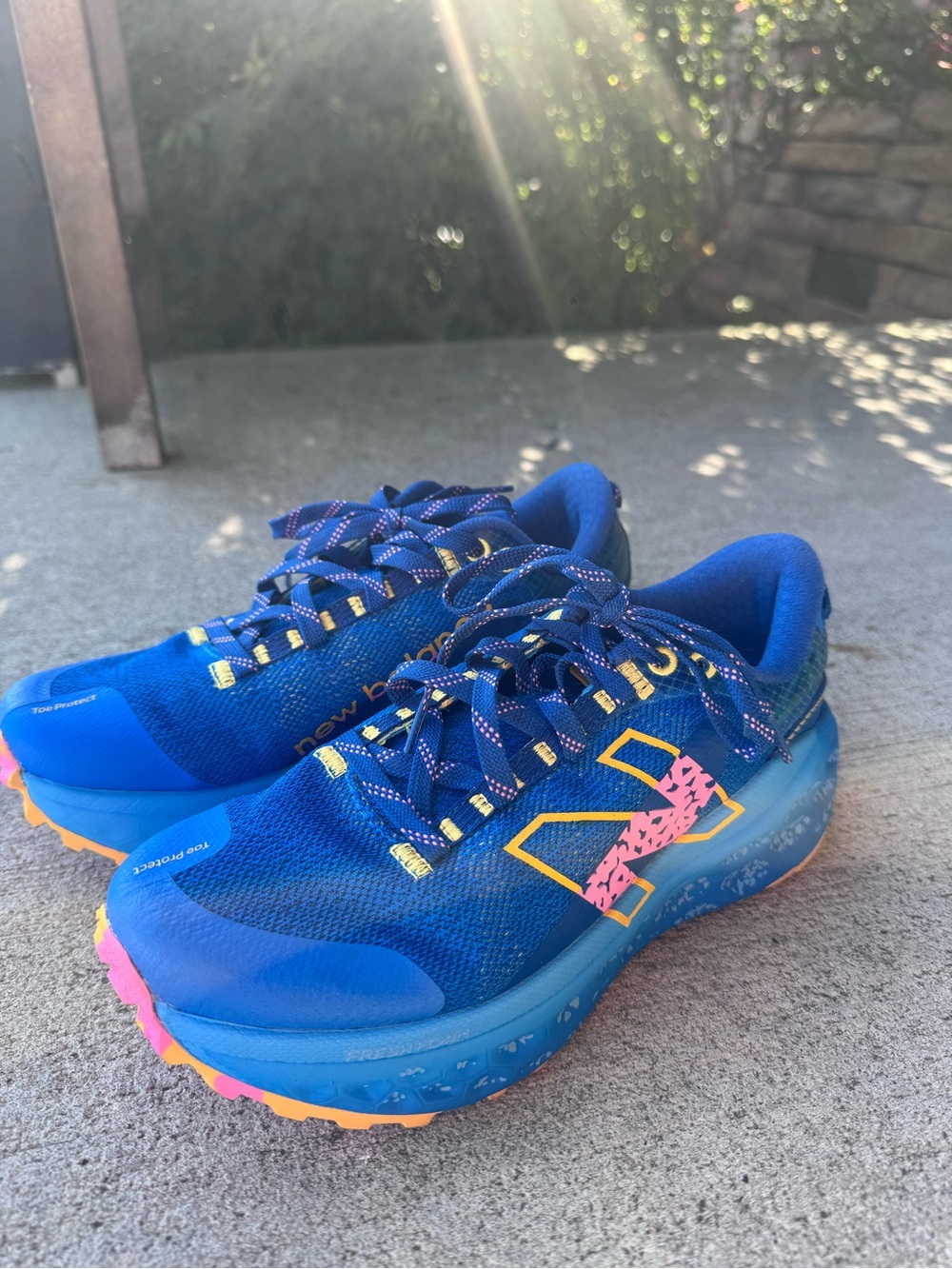 New Balance Blue Running Shoes with Pink and Yellow Accents